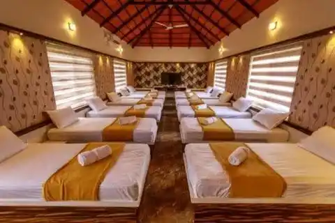 AC hall sleeping area at Shree Kshetrapal Jain Atithi Bhavan for groups and gatherings.